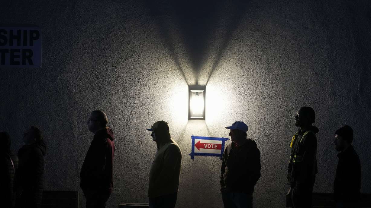Voters stand in line outside a polling place at Madison Church, Tuesday, Nov. 5, 2024, in Phoenix, Ariz.