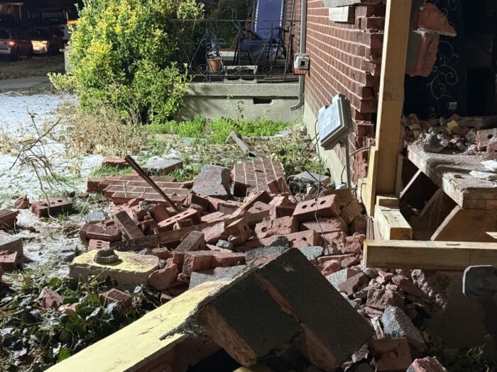 Debris is seen at a home in Magna after a truck crashed into it on Wednesday.