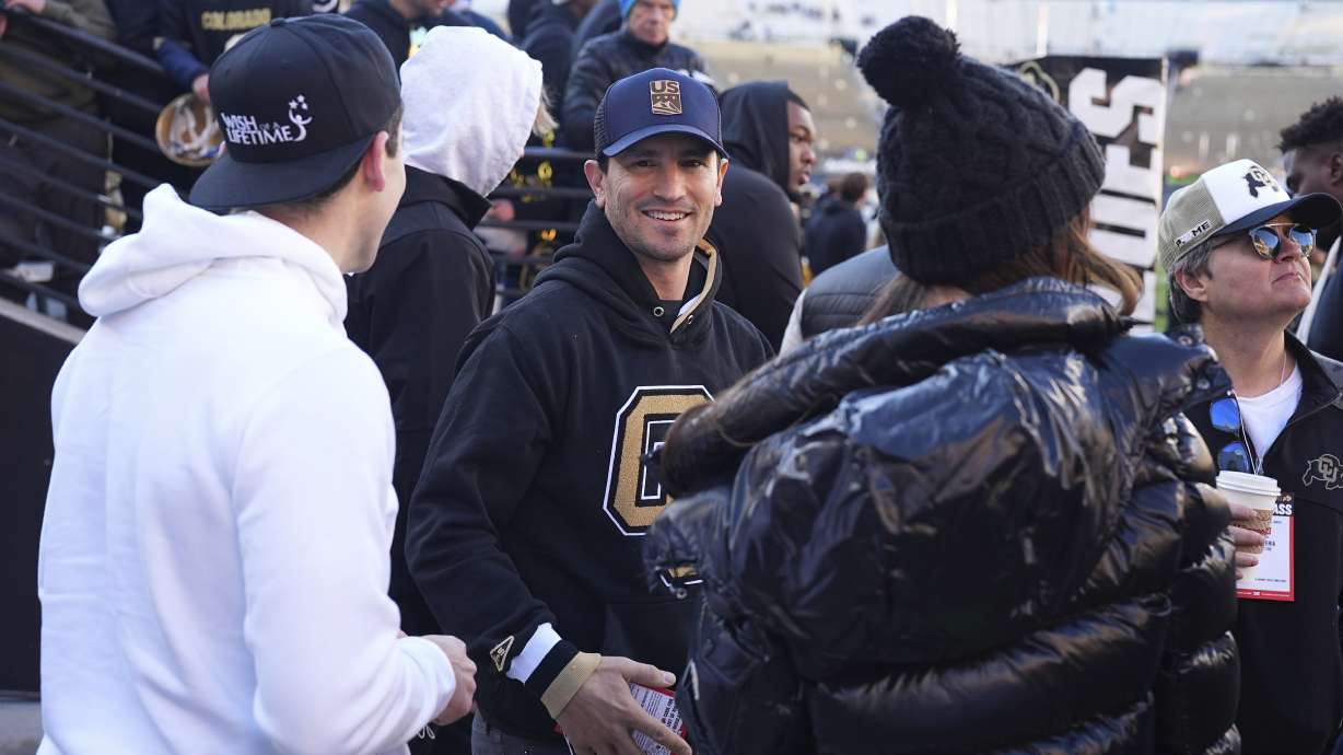 Former skier and football player Jeremy Bloom, center, is greeted by onlookers before Colorado hosts Utah in an NCAA college football game Saturday, Nov. 16, 2024, in Boulder, Colo.