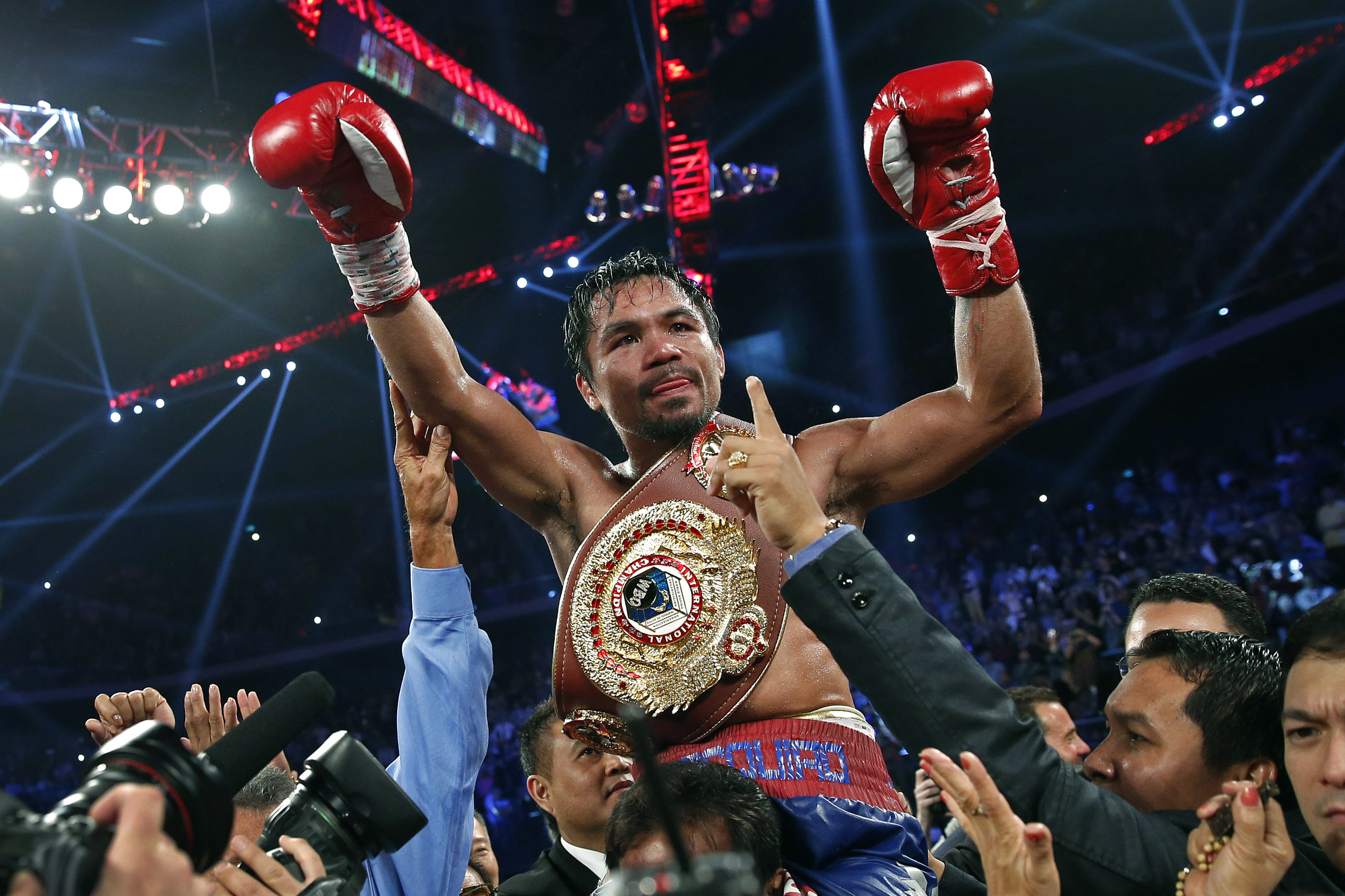 FILE - Manny Pacquiao from the Philippines wears the champion's belt after defeating Brandon Rios of the United States in their WBO international welterweight title fight Sunday, Nov. 24, 2013, in Macau. Pacquiao defeated Rios by unanimous decision.