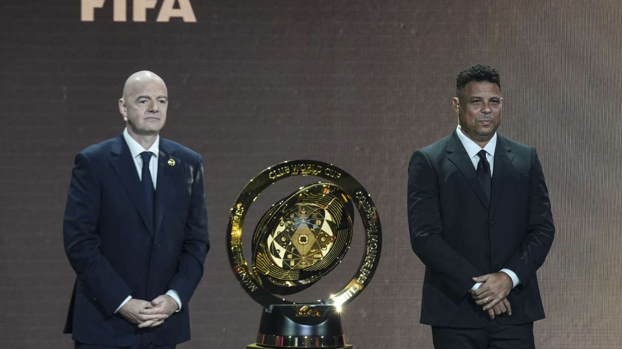 FIFA President Gianni Infantino' and Former professional Brazilian soccer player Ronaldo present a new trophy during the draw for the 2025 FIFA Club World Cup soccer tournament, Thursday, Dec. 5, 2024, in Miami.