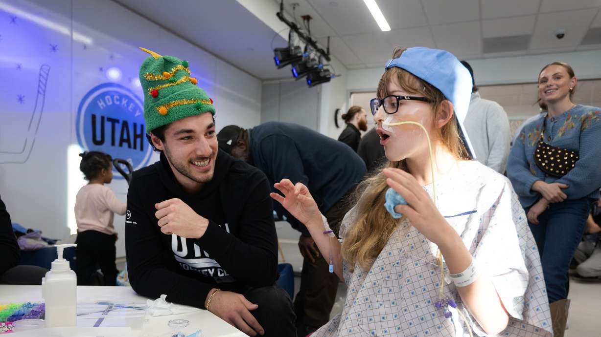 Utah Hockey’s Sean Durzi talks with Mila Shaw as members of the Utah Hockey Club visit kids at Primary Children’s Hospital in Lehi on Wednesday.