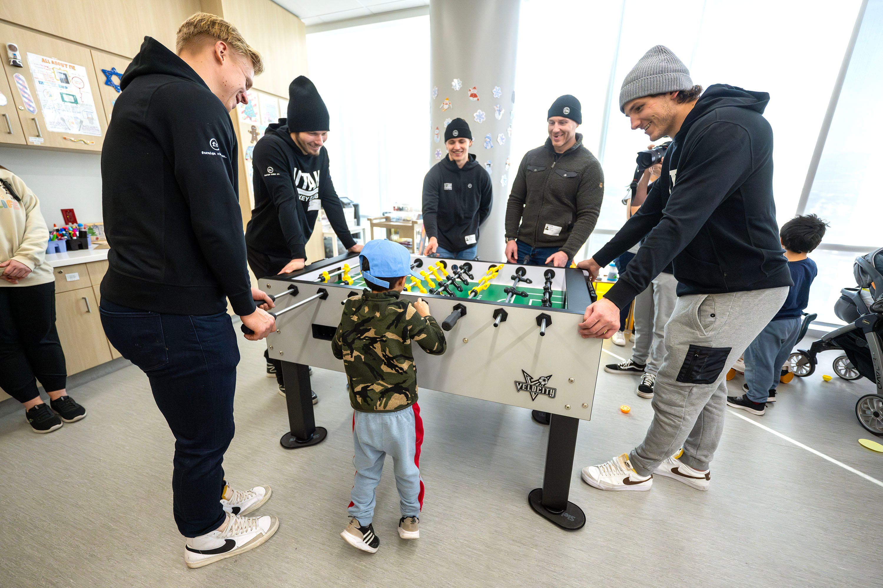 Utah HC defensemen Olli Määttä, Mikhail Sergachev, Vladislav Kolyachonok, Ian Cole, and John Marino play foosball with Rohan Perez as members of the Utah Hockey Club visit kids at Primary Children’s Hospital in Lehi on Wednesday.