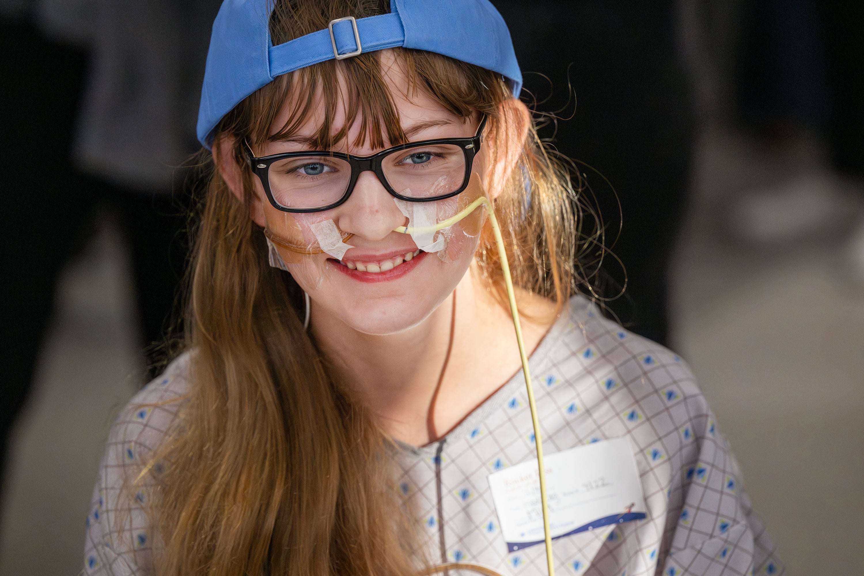 Mila Shaw smiles as she plays games with members of the Utah Hockey Club as they visit the kids at Intermountain’s Primary Children’s Hospital in Lehi on Wednesday.