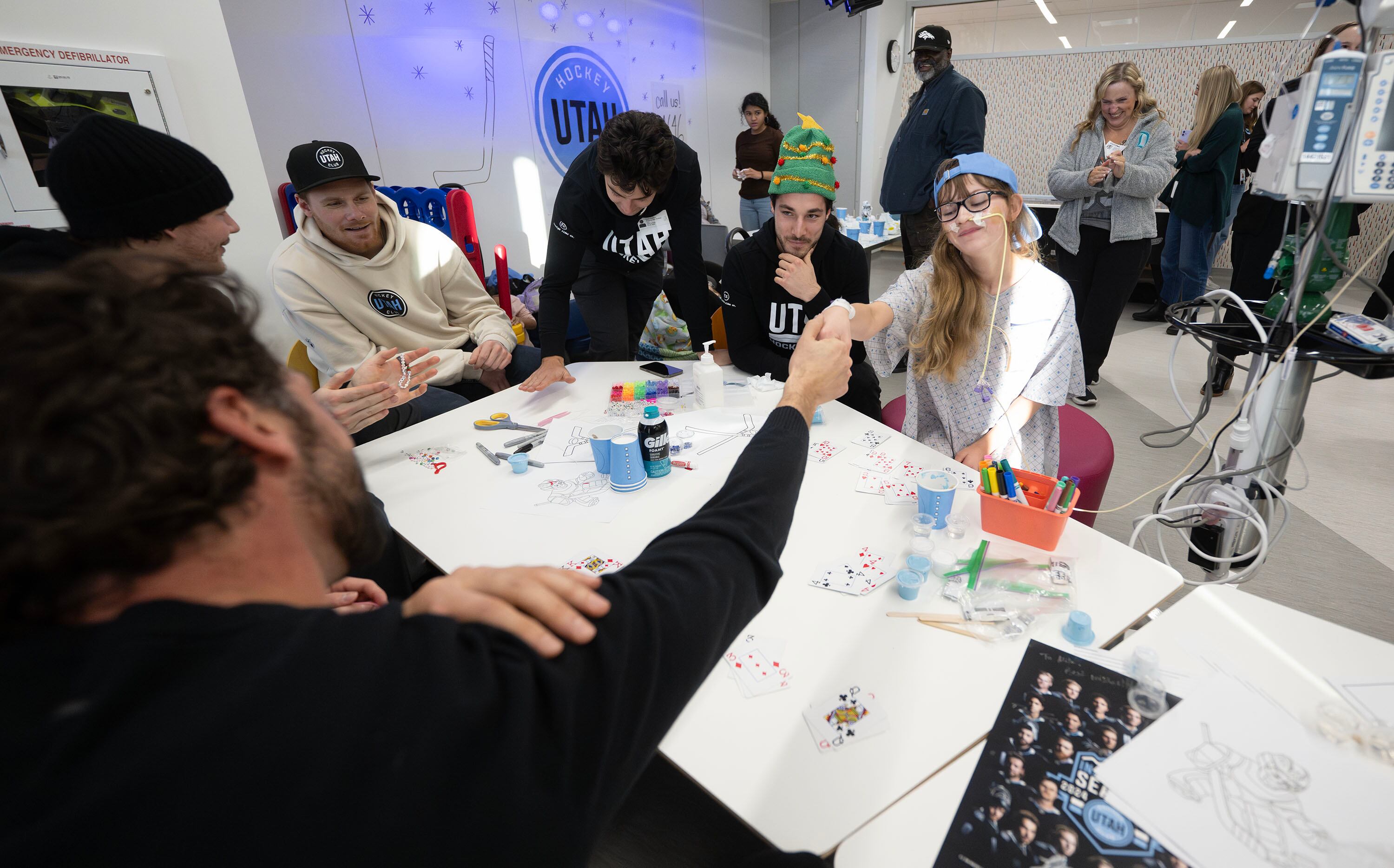 Utah HC defenseman Robert Bortuzzo reaches across the table to shake hands with Mila Shaw after they played an intense game of Go Fish as members of the Utah Hockey Club visit kids at Primary Children’s Hospital in Lehi on Wednesday.