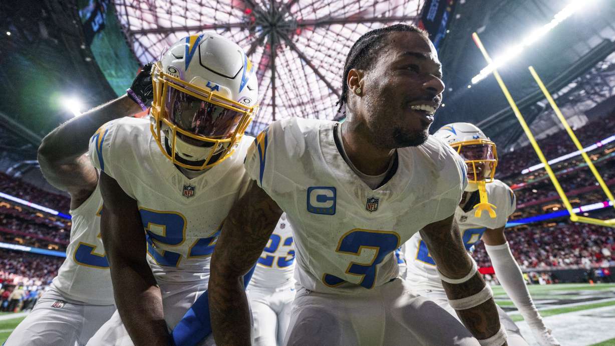 Los Angeles Chargers safety Derwin James Jr. (3) celebrates with teammates after an interception during the second half of an NFL football game against the Atlanta Falcons on Sunday, Dec. 1, 2024 in Atlanta.
