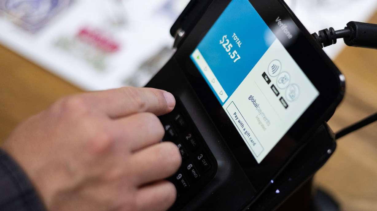 A customer purchases items at Earthbound Trading Co. in the City Creek Center in Salt Lake City on Nov. 29.