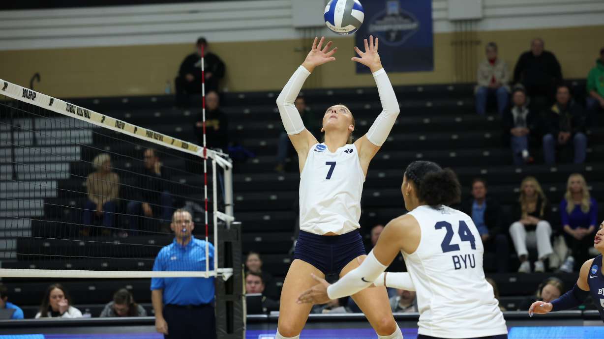 BYU setter Alex Bower serves a ball for middle hitter Brielle Kemavor (24) during an NCAA women's volleyball tournament match against Loyola Chicago, Thursday, Dec. 5, 2024 in West Lafayette, Indiana.
