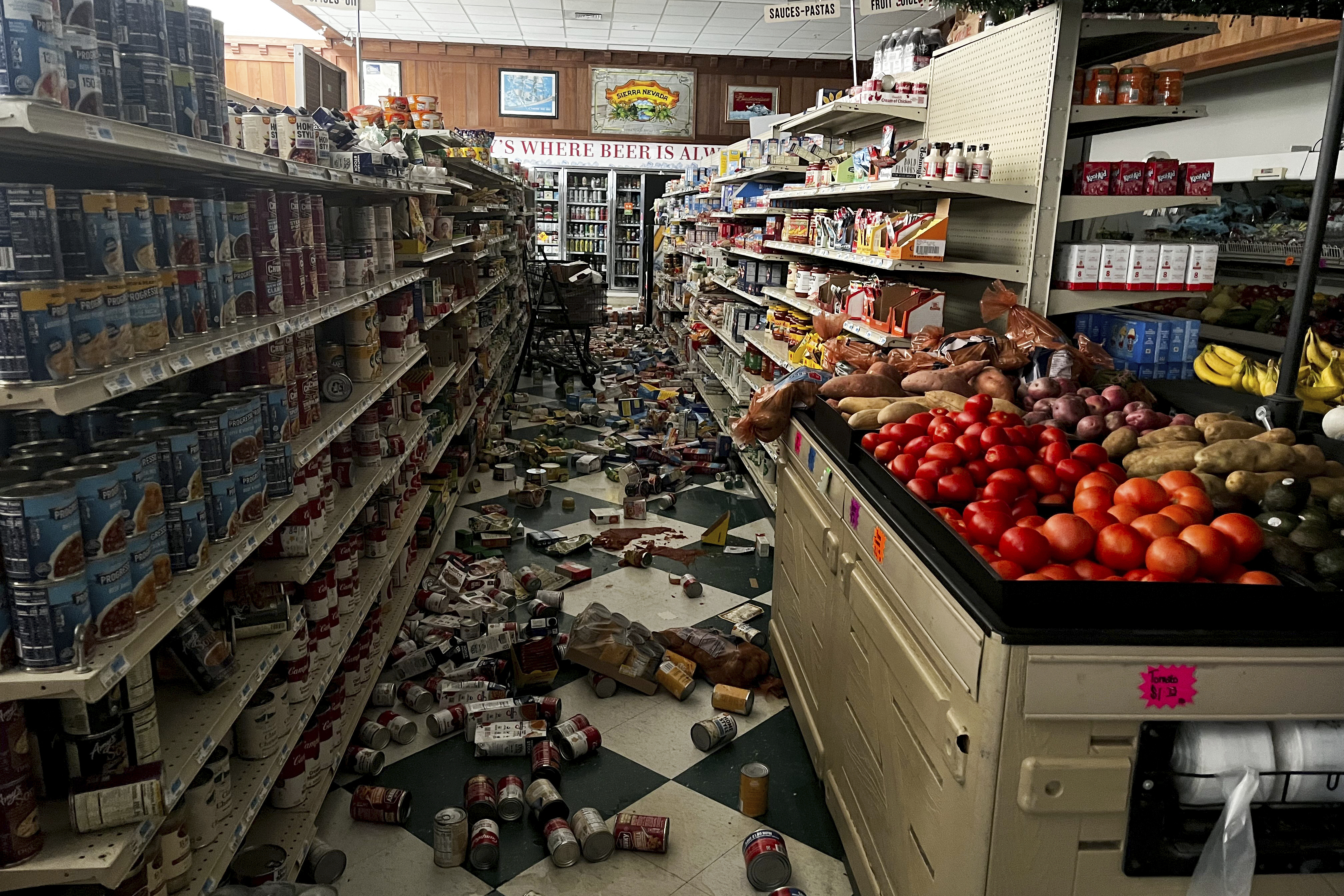 Drinks and other food items are toppled on the floor inside Hoby's Market and Deli after a 7.0 magnitude earthquake Thursday in Scotia, Calif.