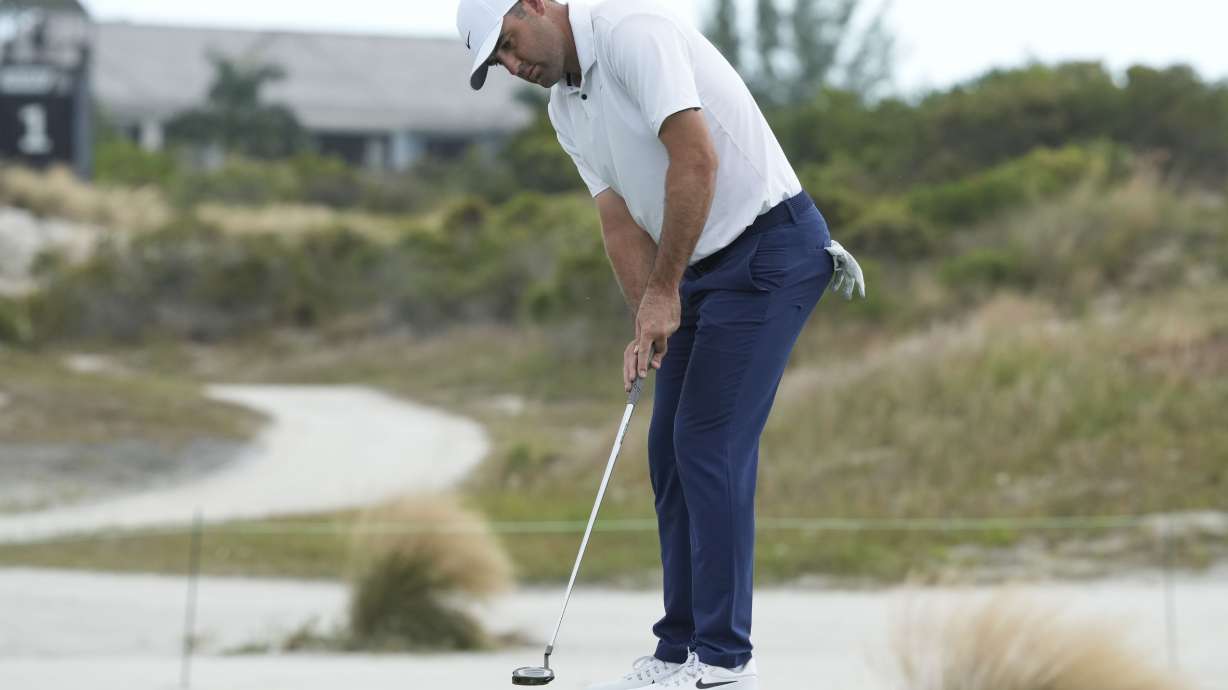 Scottie Scheffler, of the United States, watches his putt on the third green during the first round of the Hero World Challenge PGA Tour at the Albany Golf Club, in New Providence, Bahamas, Thursday, Dec. 5, 2024.