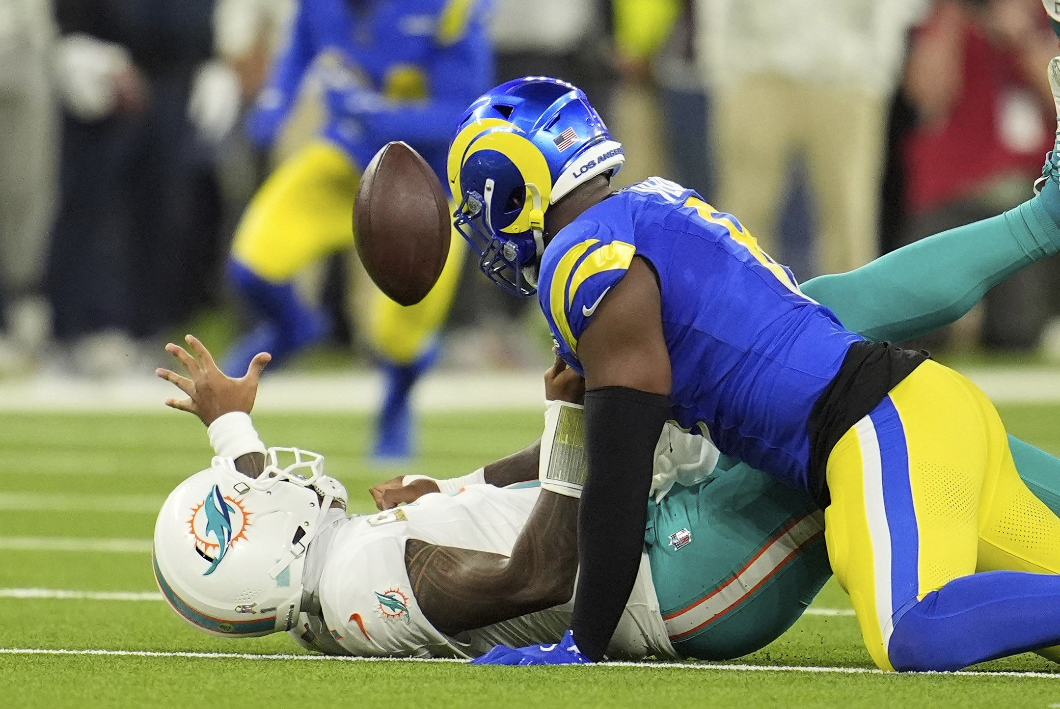 Los Angeles Rams linebacker Jared Verse, right, forces a fumble on Miami Dolphins quarterback Tua Tagovailoa during the first half of an NFL football game, Monday, Nov. 11, 2024, in Inglewood, Calif. The Rams recovered the ball.