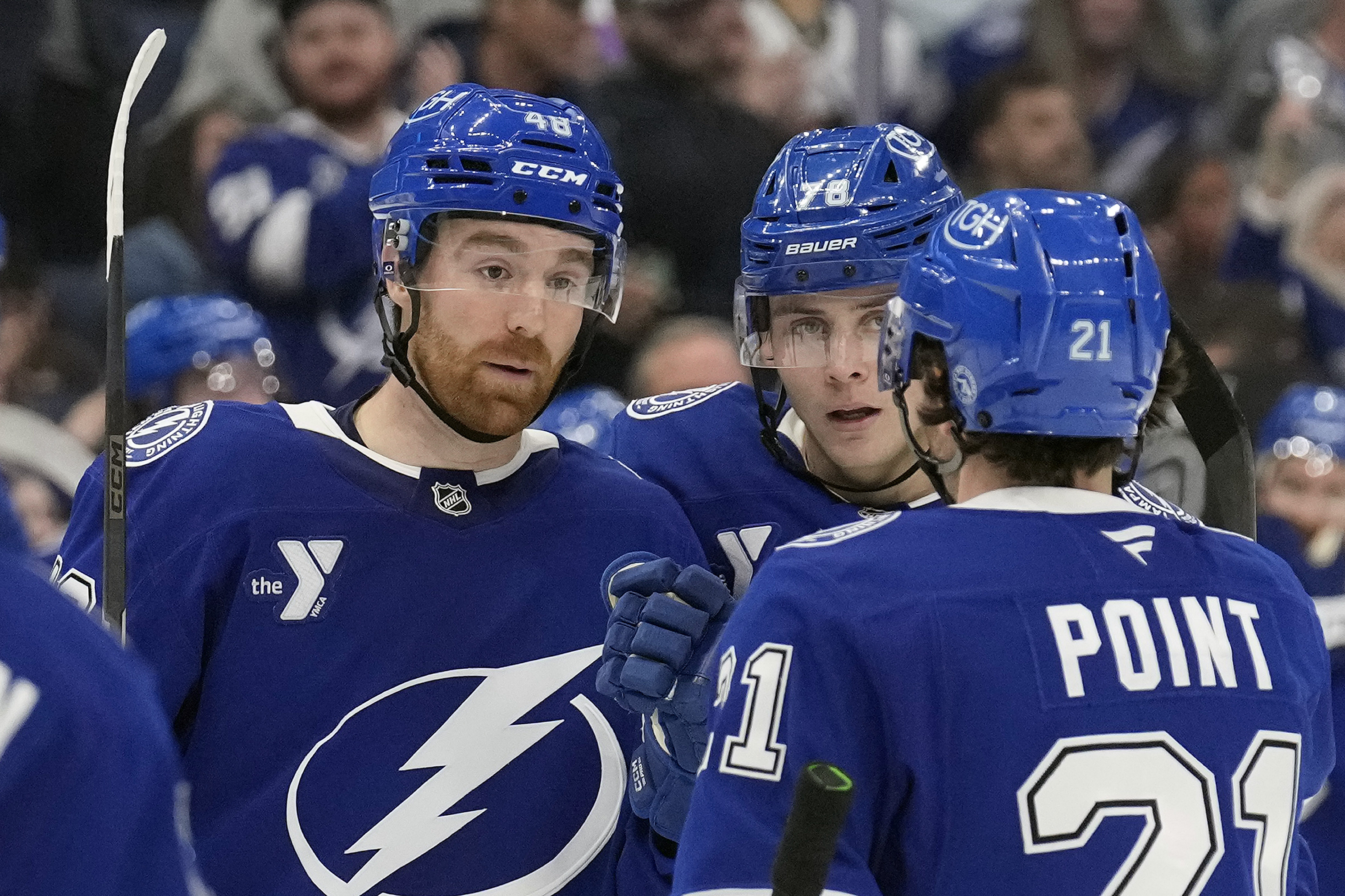 Tampa Bay Lightning defenseman Nick Perbix (48) celebrates his goal against the San Jose Sharks withn defenseman Emil Lilleberg (78) and center Brayden Point (21) during the second period of an NHL hockey game Thursday, Dec. 5, 2024, in Tampa, Fla.