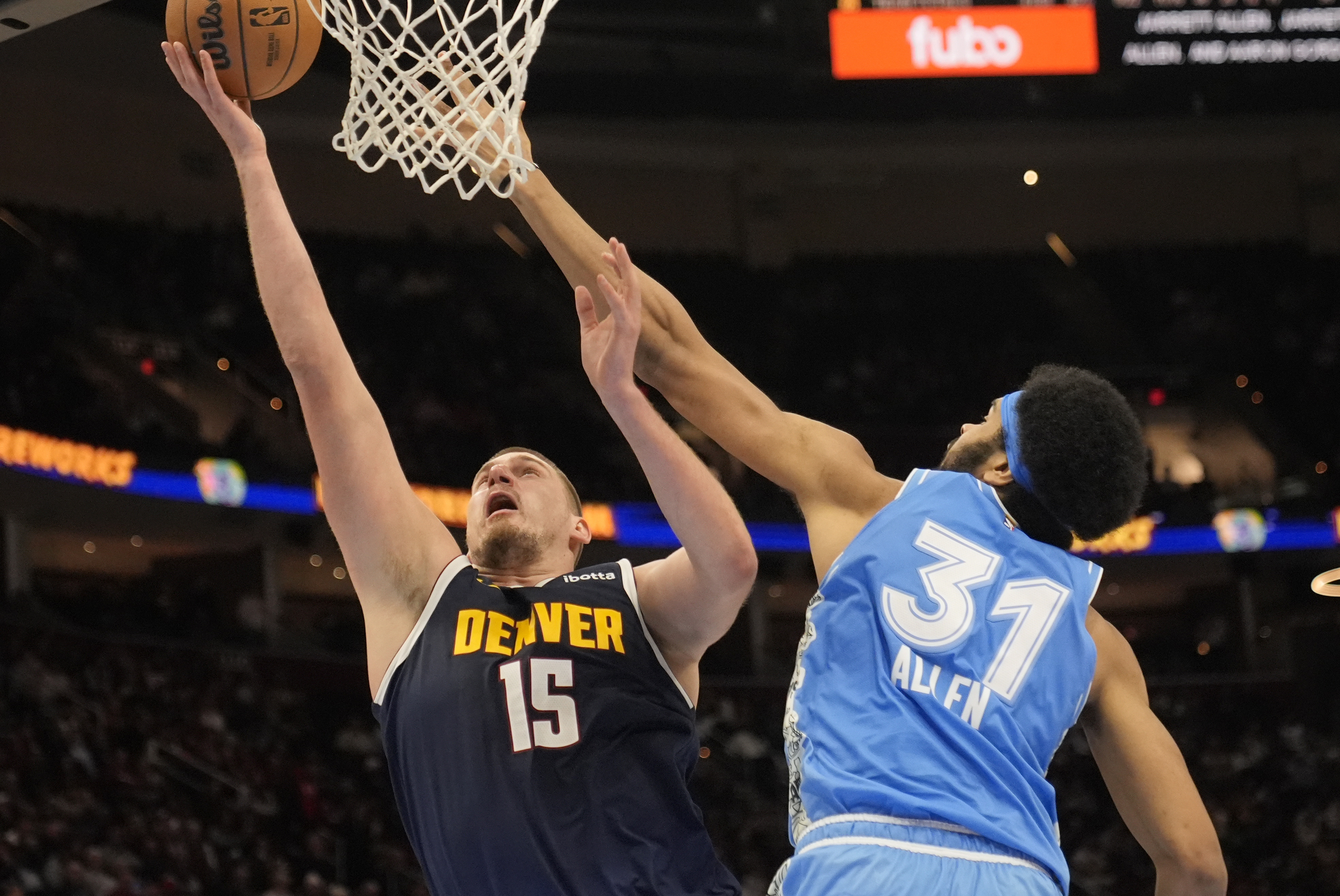 Denver Nuggets center Nikola Jokic (15) shoots in front of Cleveland Cavaliers center Jarrett Allen (31) in the second half of an NBA basketball game, Thursday, Dec. 5, 2024, in Cleveland.