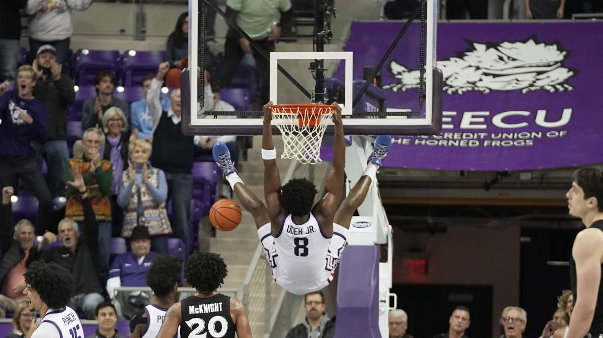 Fans cheer as TCU center Ernest Udeh Jr. (8) dunks the ball in the closing seconds of the second half of an NCAA college basketball game against Xavier in Fort Worth, Texas, Thursday, Dec. 5, 2024.