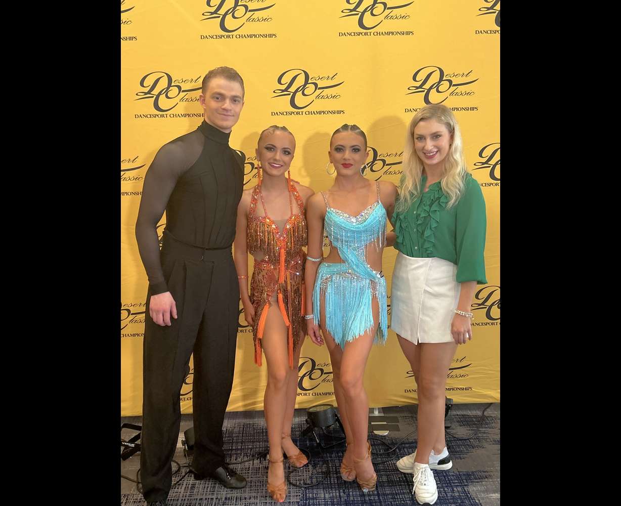 Ladu Dance Studio owners Daniel and Alexis Pollack pose with students at a ballroom competition in California.