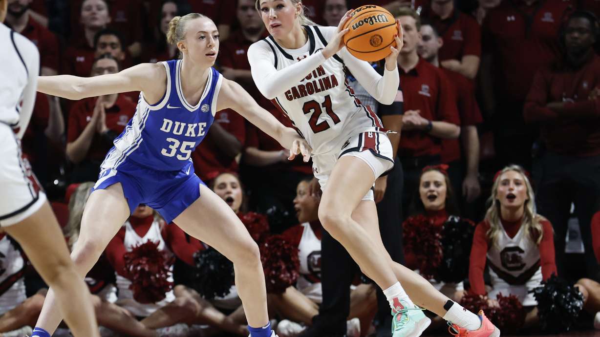 South Carolina forward Chloe Kitts (21) looks to pass the ball against Duke forward Toby Fournier (35) during the first half of an NCAA college basketball game in Columbia, S.C., Thursday, Dec. 5, 2024.