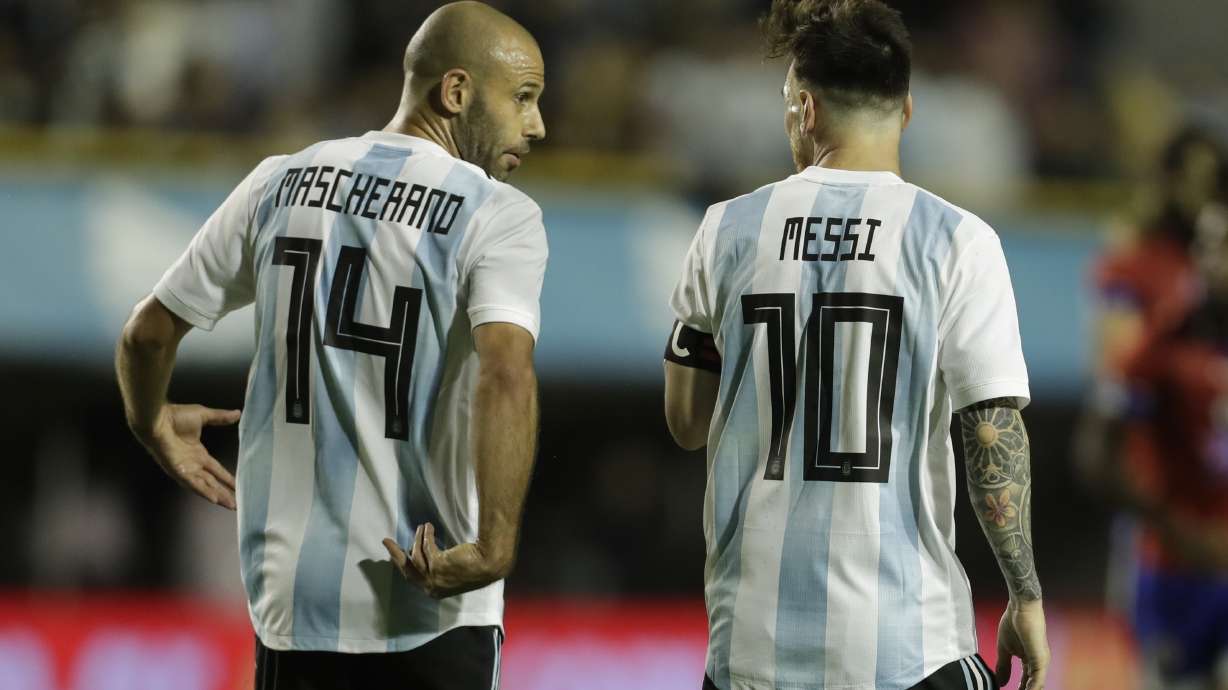 FILE - Argentina's Javier Mascherano, left, and Lionel Messi talk after Messi scored during a friendly soccer match between Argentina and Haiti in Buenos Aires, Argentina, on May 29, 2018.