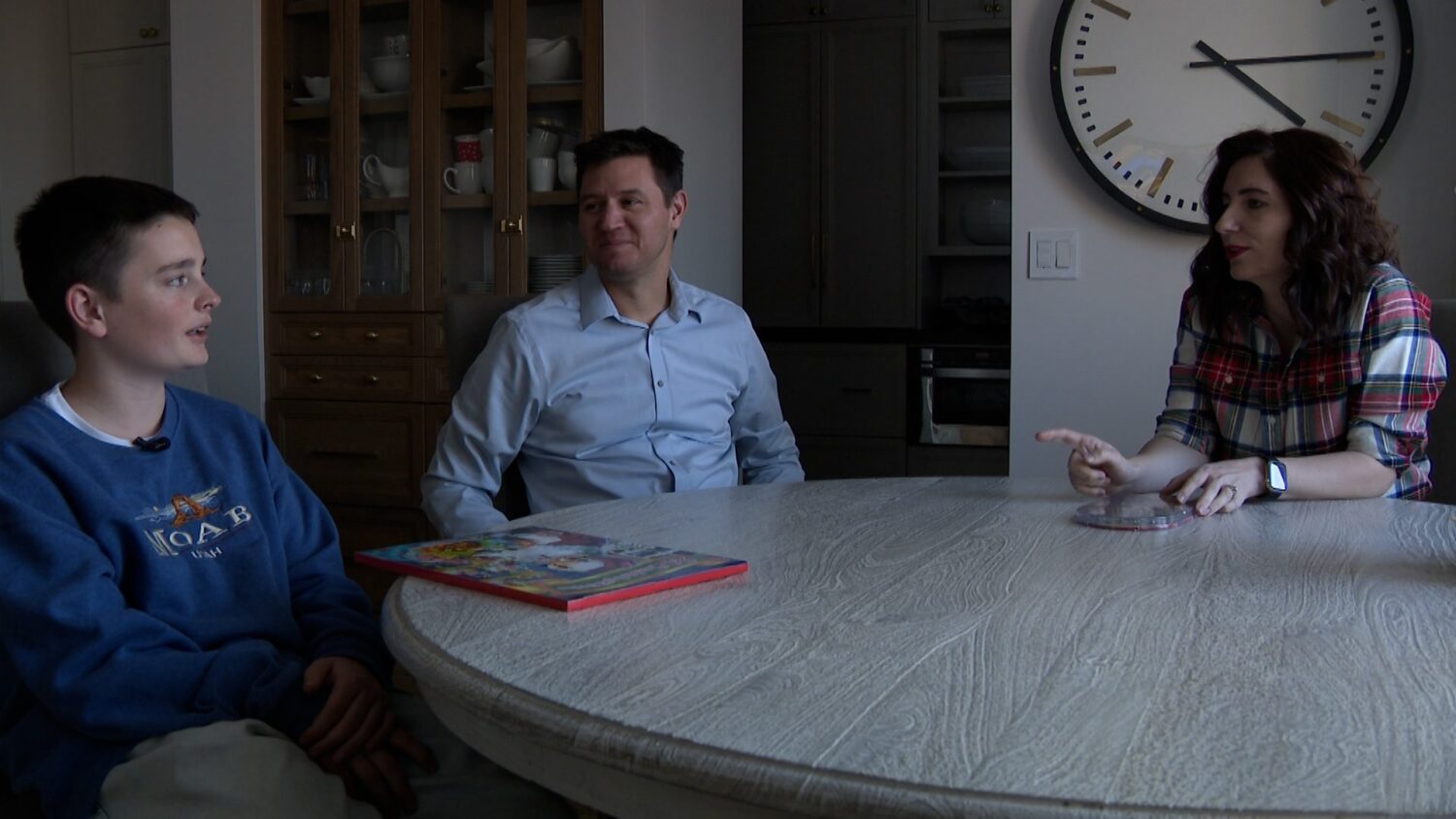 Viktor Lehostaiev and his host family, Svitlana and Darin Miller, in North Salt Lake on Thursday.