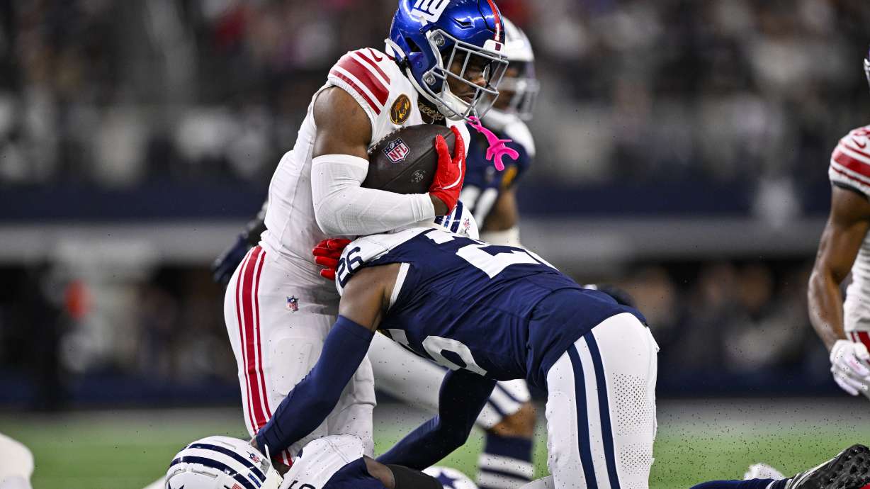 New York Giants wide receiver Malik Nabers (1) is tackled by Dallas Cowboys cornerback DaRon Bland (26) during the first half of an NFL football game in Arlington, Texas, Thursday, Nov. 28, 2024.