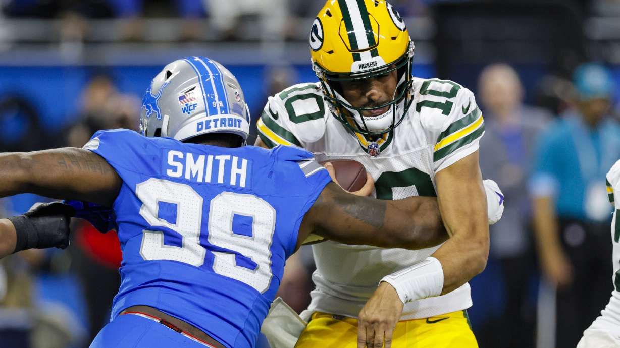 Detroit Lions defensive end Za'Darius Smith (99) sacks Green Bay Packers quarterback Jordan Love (10) during the first half of an NFL football game in Detroit, Thursday, Dec. 5, 2024.