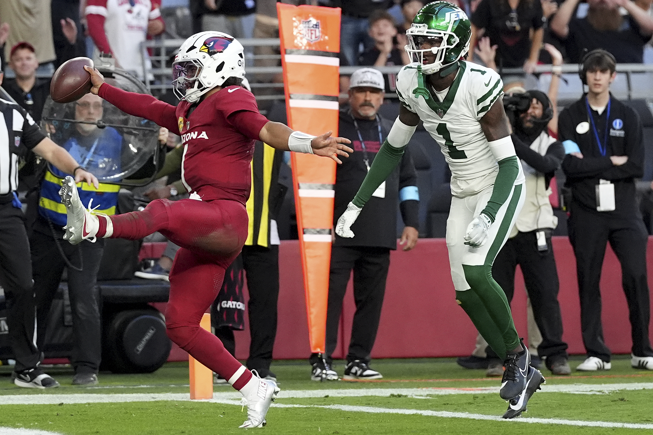 Arizona Cardinals quarterback Kyler Murray, left, scores a touchdown as New York Jets cornerback Sauce Gardner (1) defends during the second half of an NFL football game, Sunday, Nov. 10, 2024, in Glendale, Ariz.
