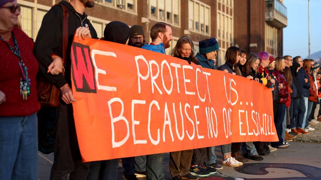 Teachers and staff link arms in solidarity to protest the lack of school safety at West High School in Salt Lake City on Friday.