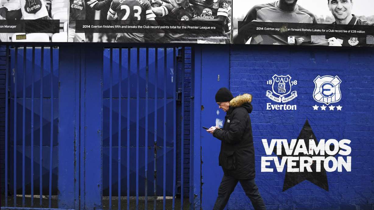 A man walks outside Goodison Park as the Premier League soccer match between Everton and Liverpool is called off due to storm Darragh at Goodison Park, in Liverpool, England, Saturday Dec 7, 2024.