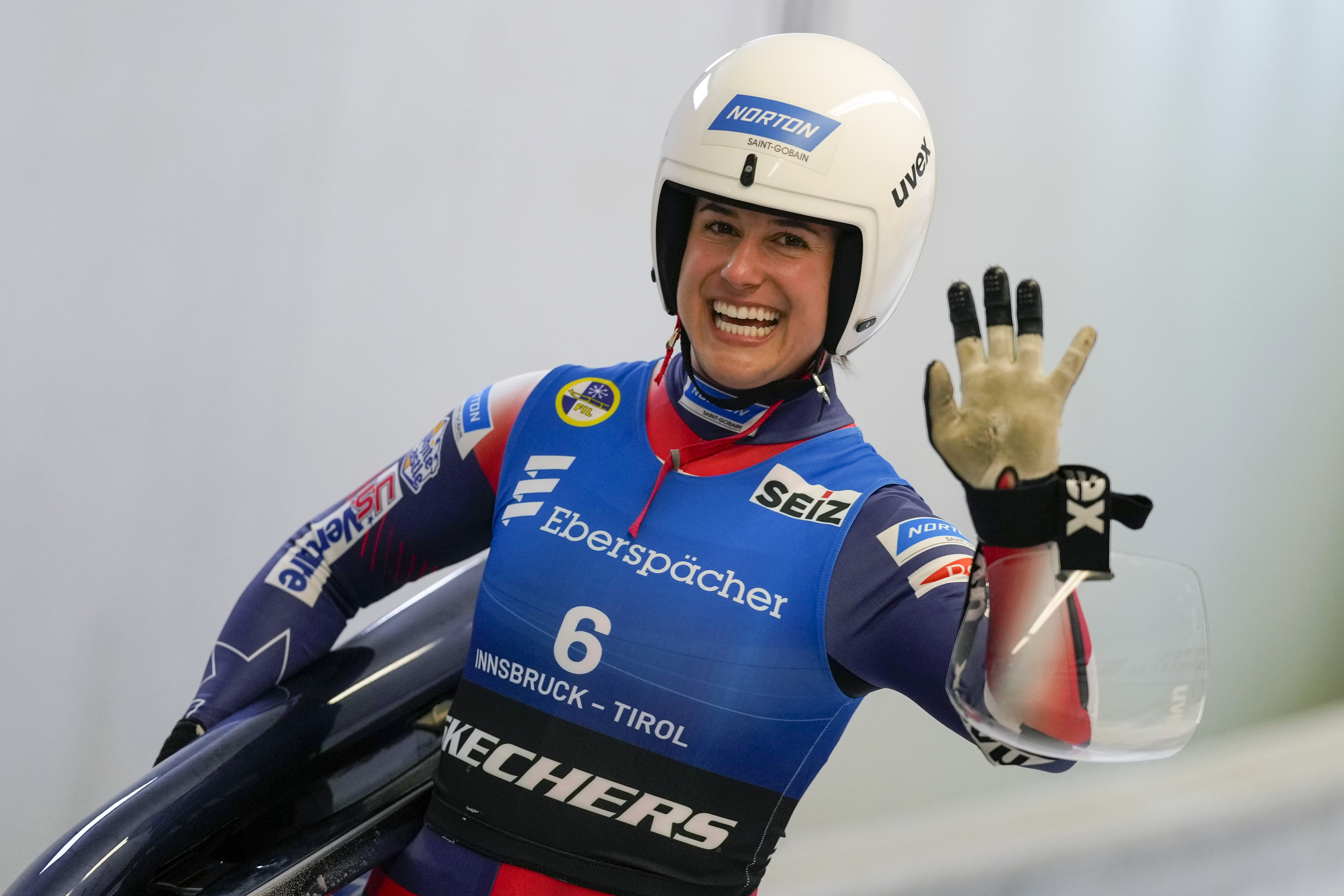 Emily Sweeney of the United States waves after the women's sprint race at the Luge World Cup in Igls near Innsbruck, Austria, Saturday, Dec. 7, 2024. 