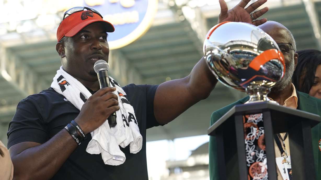 FILE - Then-Florida A&M head coach Willie Simmons stands with the trophy after the Orange Blossom Classic NCAA college football game against Jackson State, Sunday, Sept. 3, 2023, in Miami Gardens, Fla.