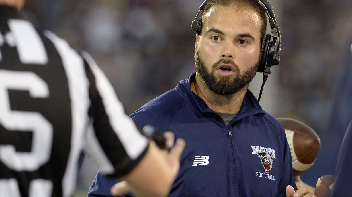 Maine head coach Joe Harasymiak, right, looks at an official during the first half of an NCAA college football game against Connecticut , Thursday, Sept. 1, 2016, in East Hartford, Conn.