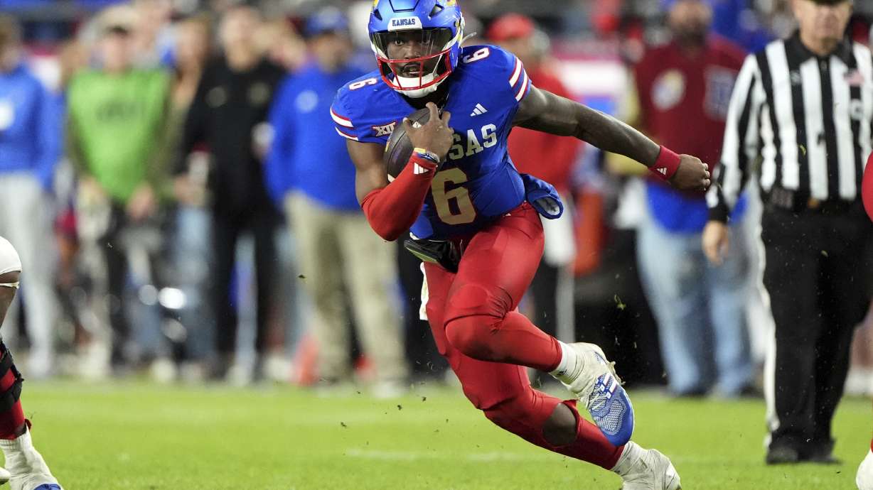 Kansas quarterback Jalon Daniels runs the ball during the second half of an NCAA college football game against Colorado, Saturday, Nov. 23, 2024, in Kansas City, Mo.