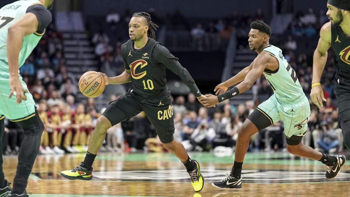 Cleveland Cavaliers guard Darius Garland (10) drives past Charlotte Hornets forward Brandon Miller (24) during the first half of an NBA basketball game, Saturday, Dec. 7, 2024, in Charlotte, N.C.