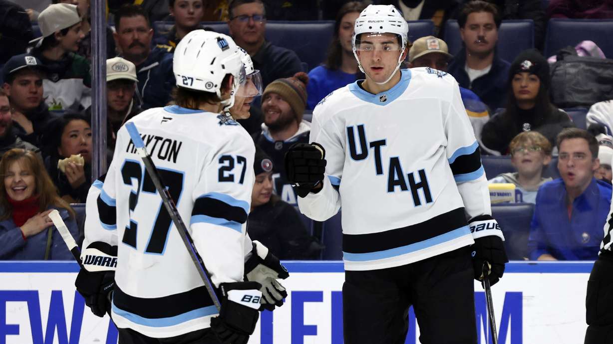 Utah Hockey Club defenseman Michael Kesselring (7) celebrates his goal with center Barrett Hayton (27) during the second period of an NHL hockey game against the Buffalo Sabres, Saturday, Dec. 7, 2024, in Buffalo, N.Y.
