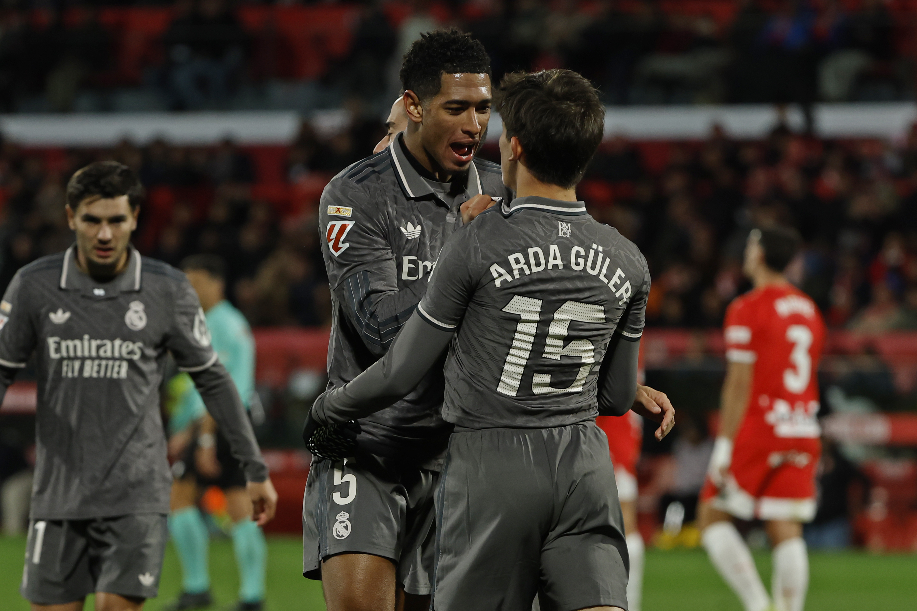 Real Madrid's Arda Guler, centre right, is congratulated by Jude Bellingham after scoring his side's second goal during a Spanish La Liga soccer match between Girona and Real Madrid at the Montilivi stadium in Girona, Spain, Saturday, Dec. 7, 2024.