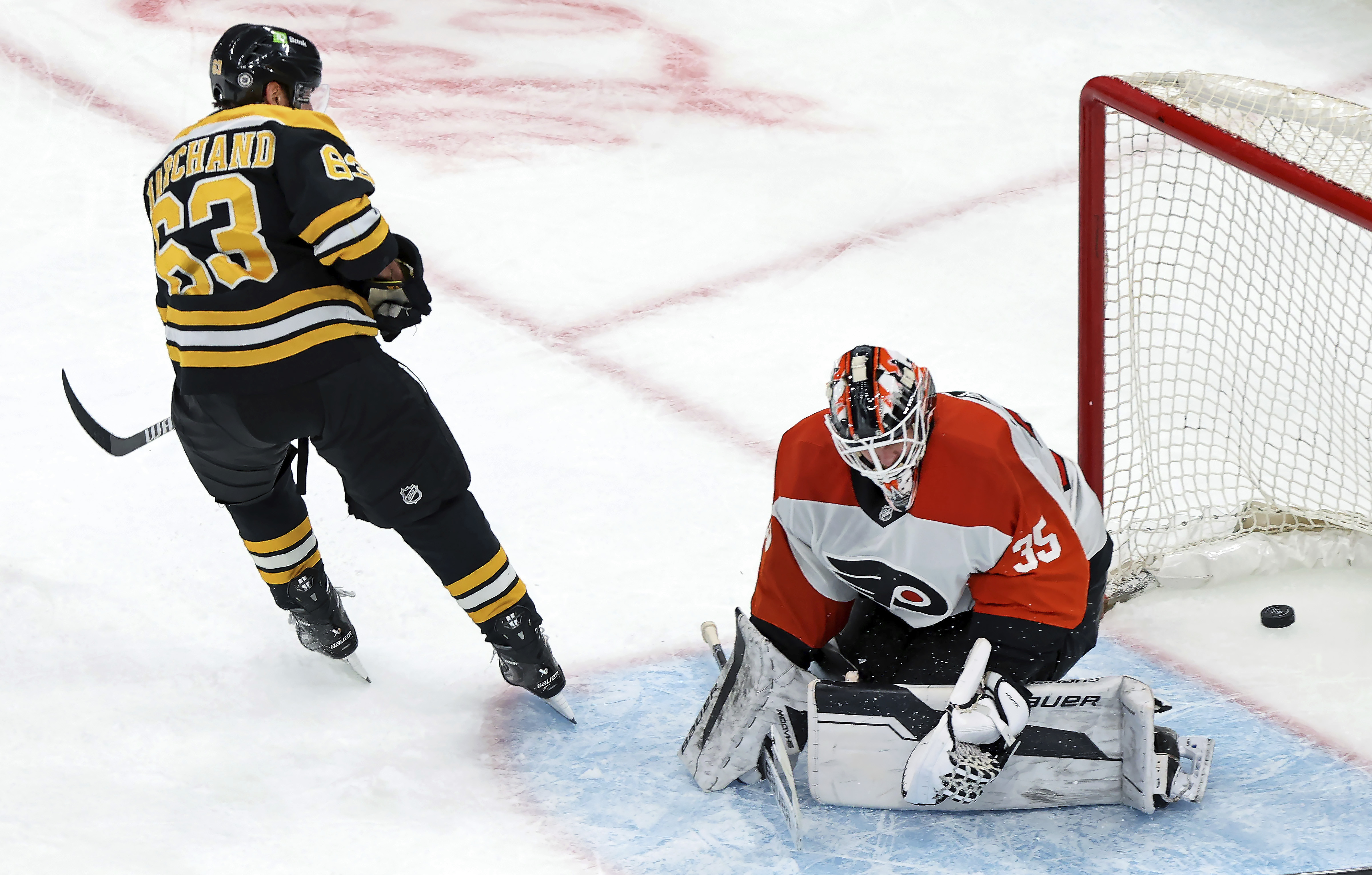 Boston Bruins captain Brad Marchand (63) scores past Philadelphia Flyers goalie Aleksei Kolosov late in the third period of an NHL hockey game, Saturday, Dec. 7, 2024, in Boston.