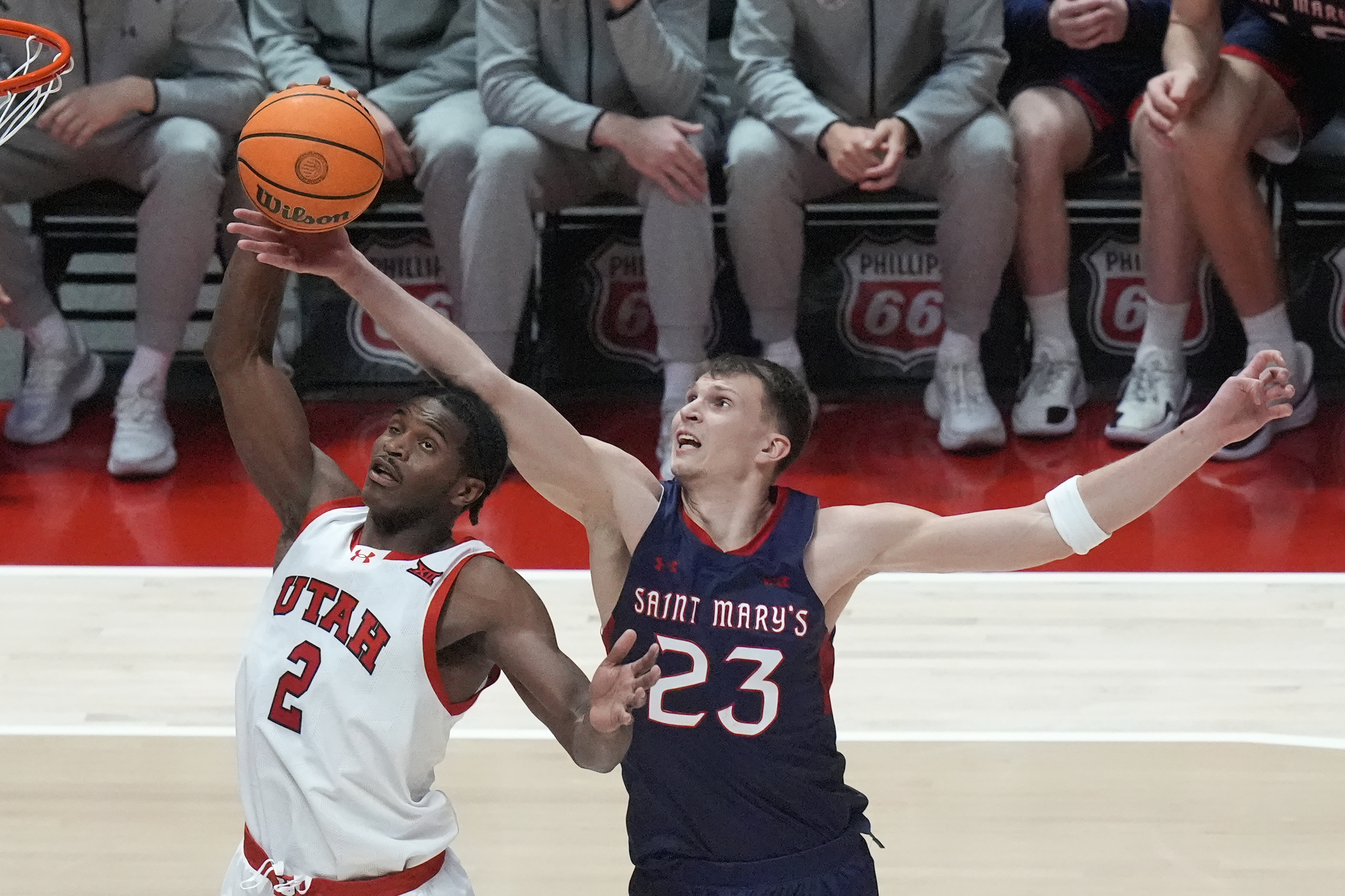 Saint Mary's forward Paulius Murauskas (23) defends against Utah forward Ezra Ausar (2) during the second half of an NCAA college basketball game Saturday, Dec. 7, 2024, in Salt Lake City.