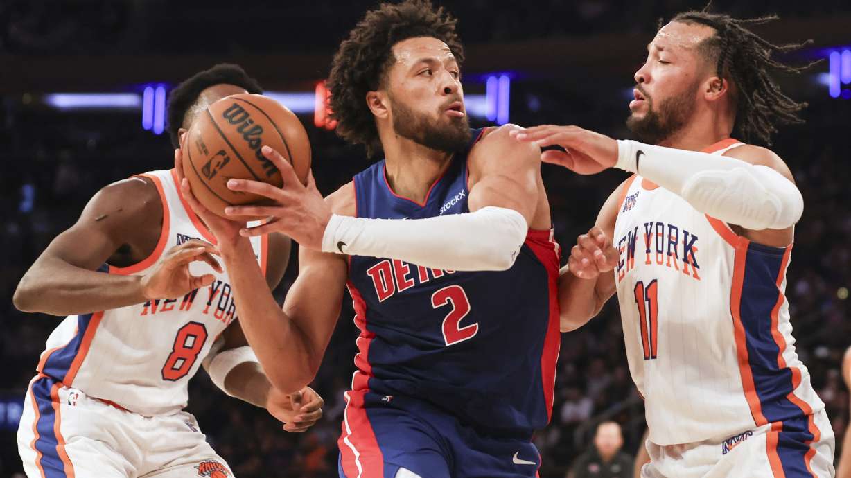 Detroit Pistons' Cade Cunningham is defended by New York Knicks' Jalen Brunson during the first half of an NBA basketball game, Saturday, Dec. 7, 2024, in New York.
