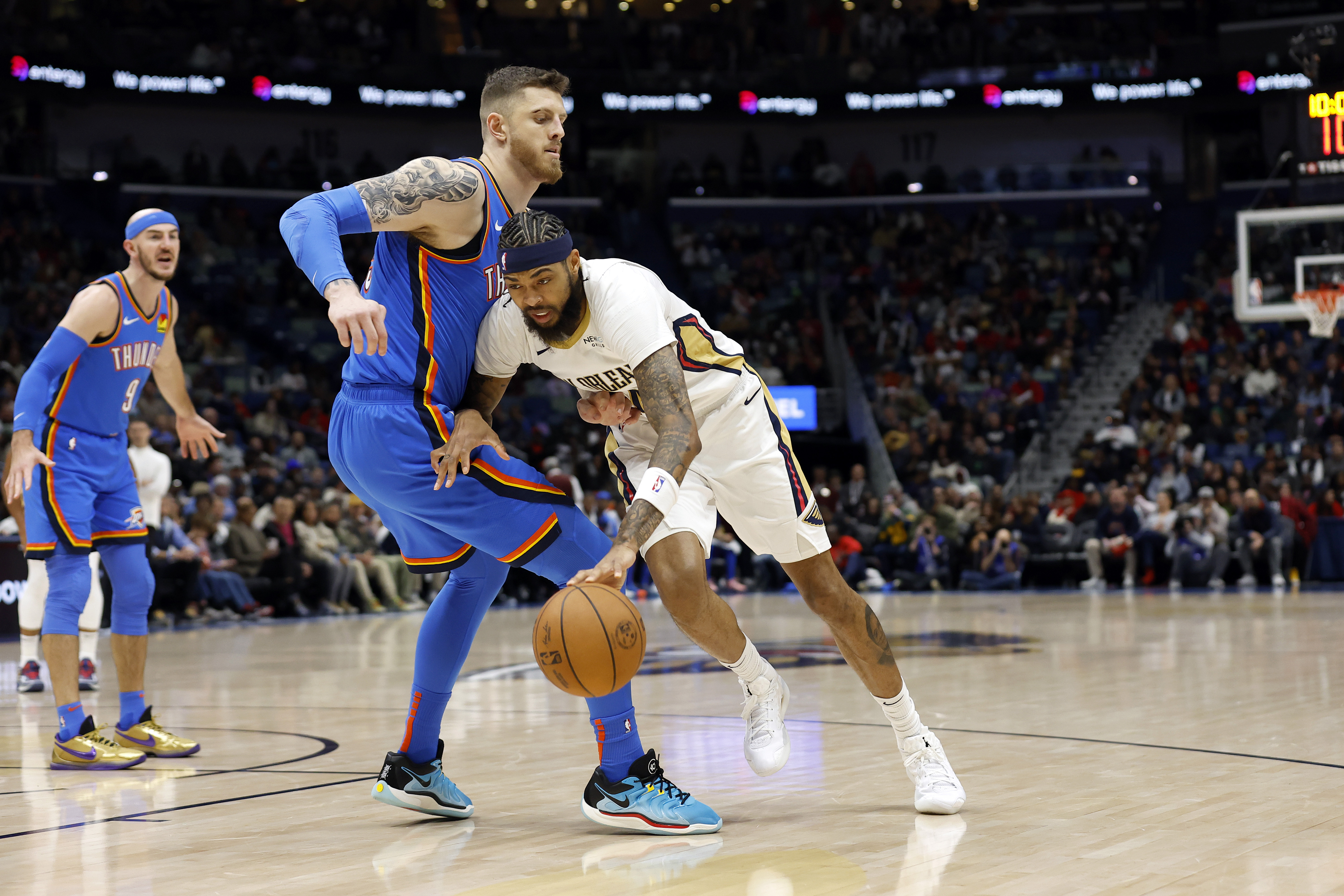 New Orleans Pelicans forward Brandon Ingram (14) drives to the basket as Oklahoma City Thunder center Isaiah Hartenstein (55) defends in the first half of an NBA basketball game in New Orleans, Saturday, Dec. 7, 2024.