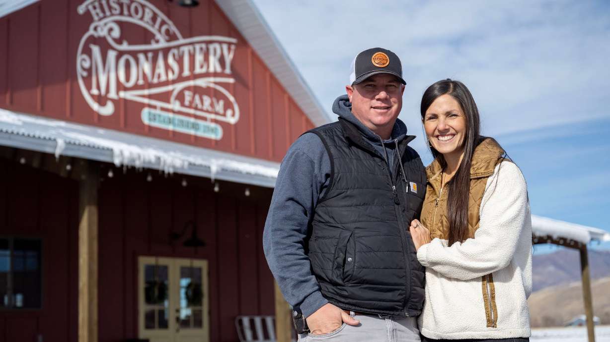 Kenny and Jamila McFarland, who lease the land, pose for a photo at the red barn at the Historic Monastery Farm in Huntsville, Nov. 25.