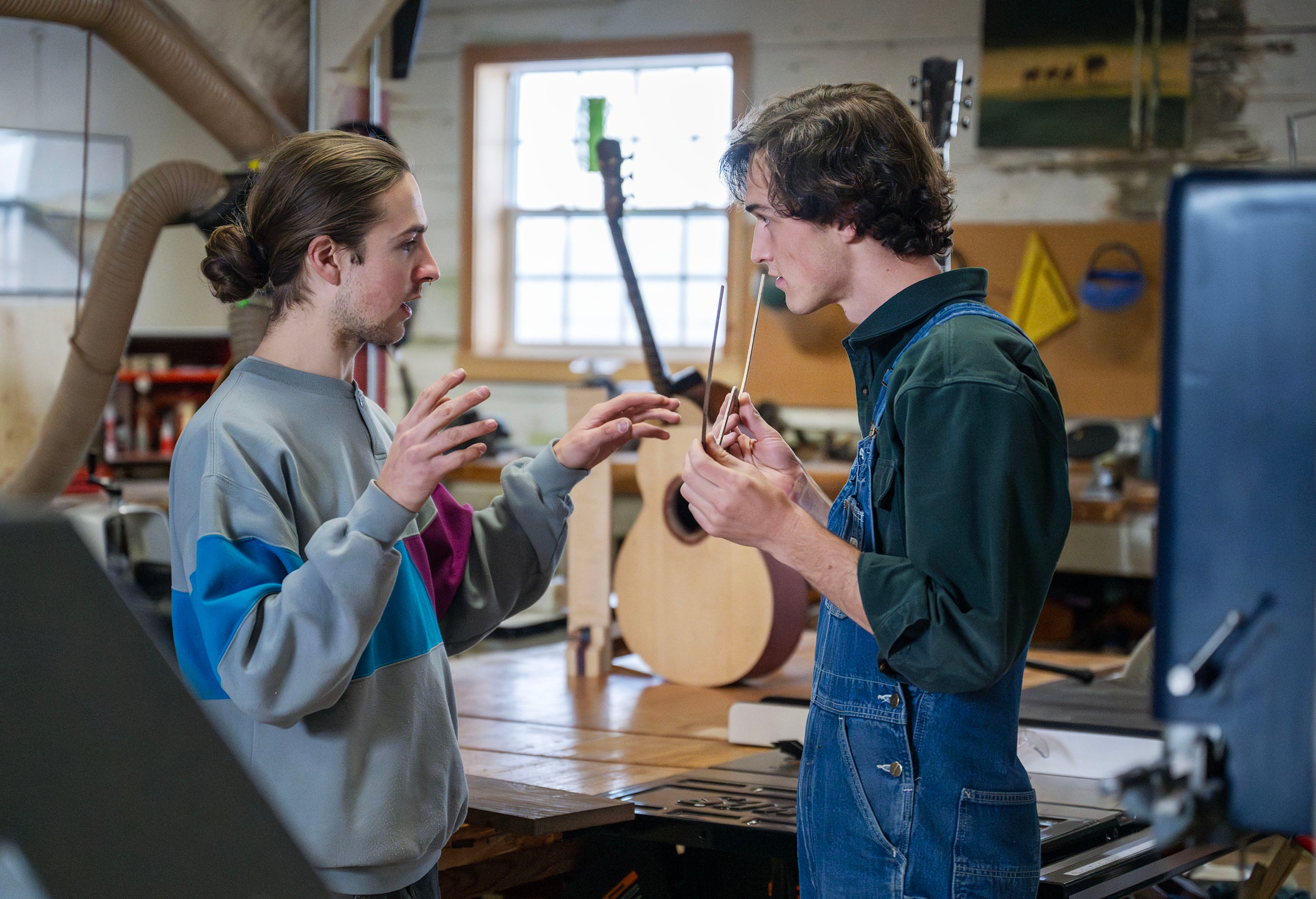 Woodworkers Ayden Hofmeister and friend Jack White talk while in their shop at the Historic Monastery Farm in Huntsville, Nov. 25.