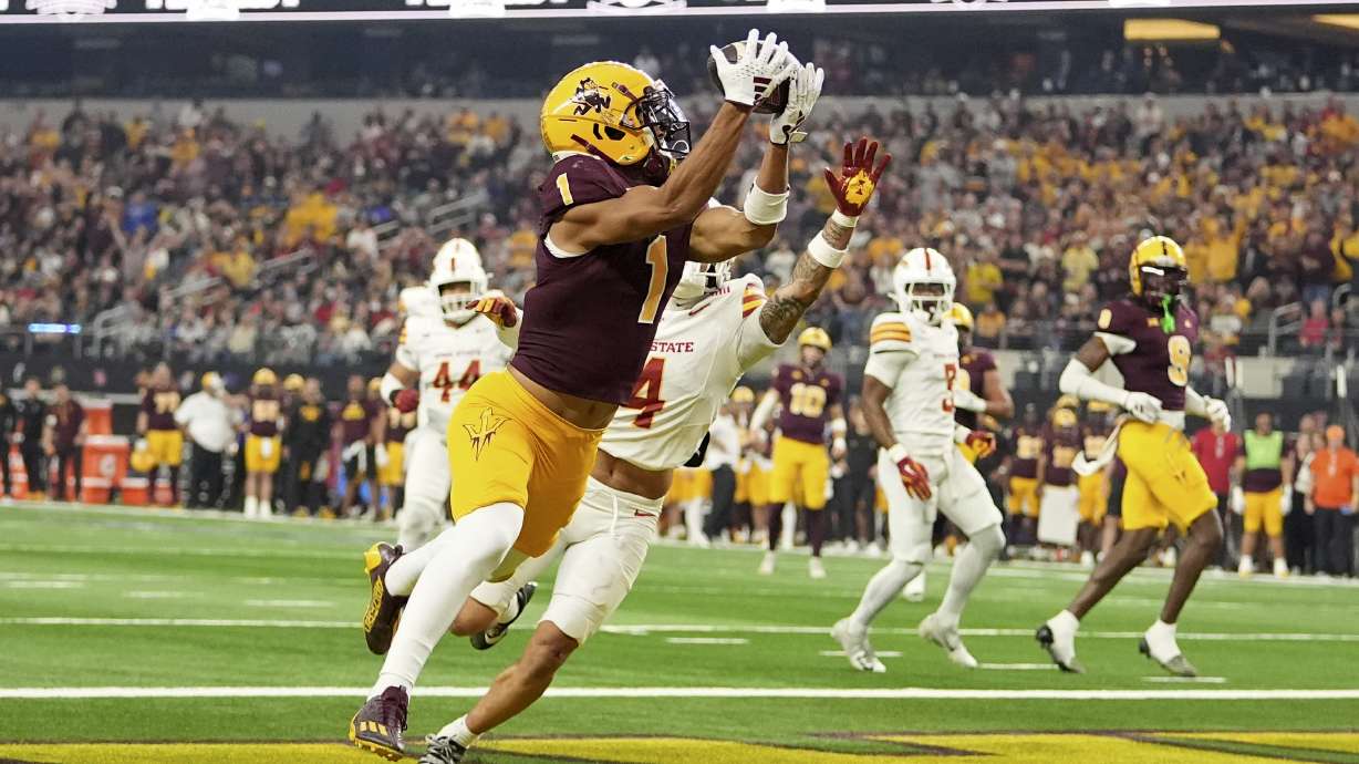 Arizona State wide receiver Xavier Guillory (1) catches a touchdown pass as Iowa State defensive back Jeremiah Cooper, rear, defends in the second half of the Big 12 Conference championship NCAA college football game, in Arlington, Texas, Saturday Dec. 7, 2024.
