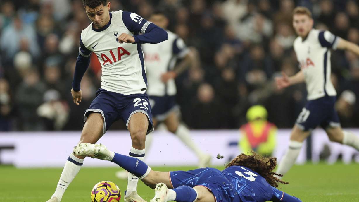 Tottenham's Brennan Johnson challenges for the ball with Chelsea's Marc Cucurella during the English Premier League soccer match between Tottenham Chelsea, at the Hotspur stadium in London, Sunday, Dec.8, 2024.