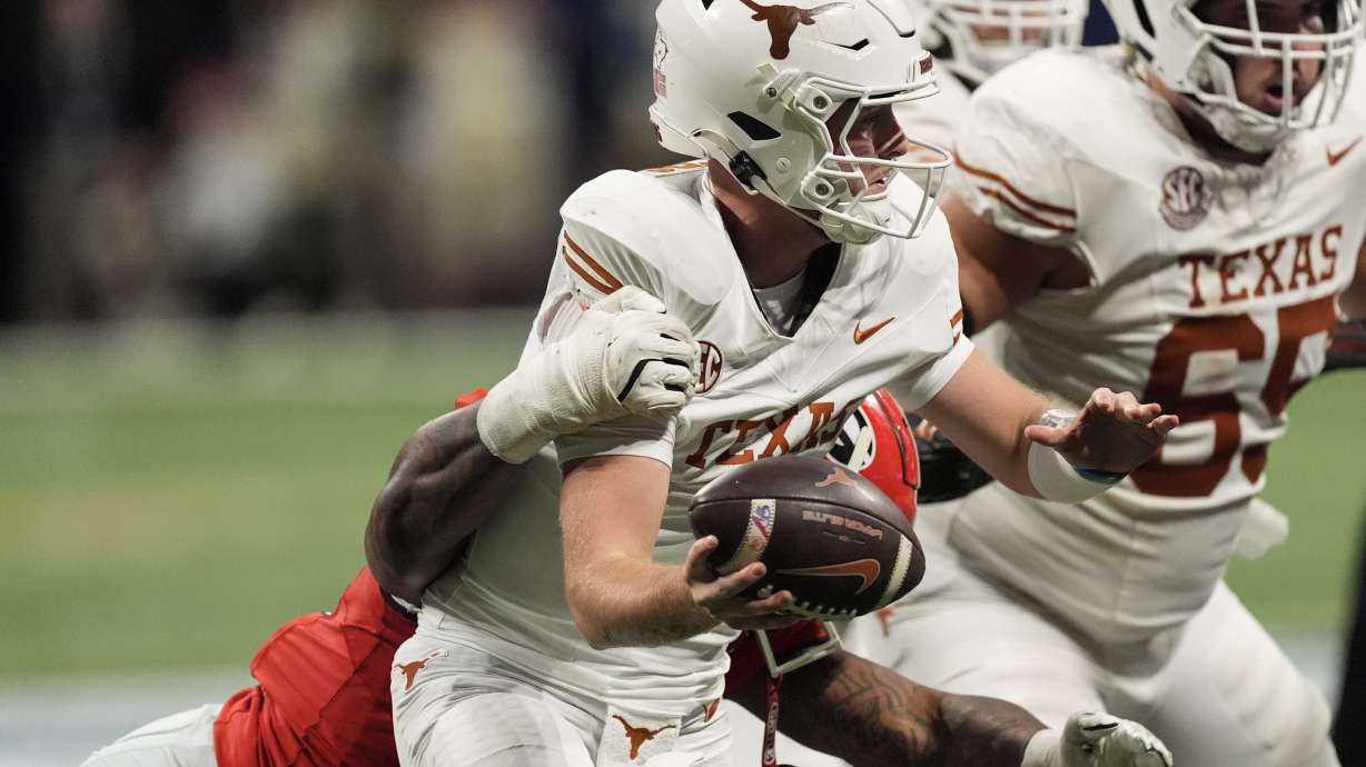 Georgia defensive lineman Mykel Williams (13) sacks Texas quarterback Quinn Ewers (3) during the second half of the Southeastern Conference championship NCAA college football game, Saturday, Dec. 7, 2024, in Atlanta.