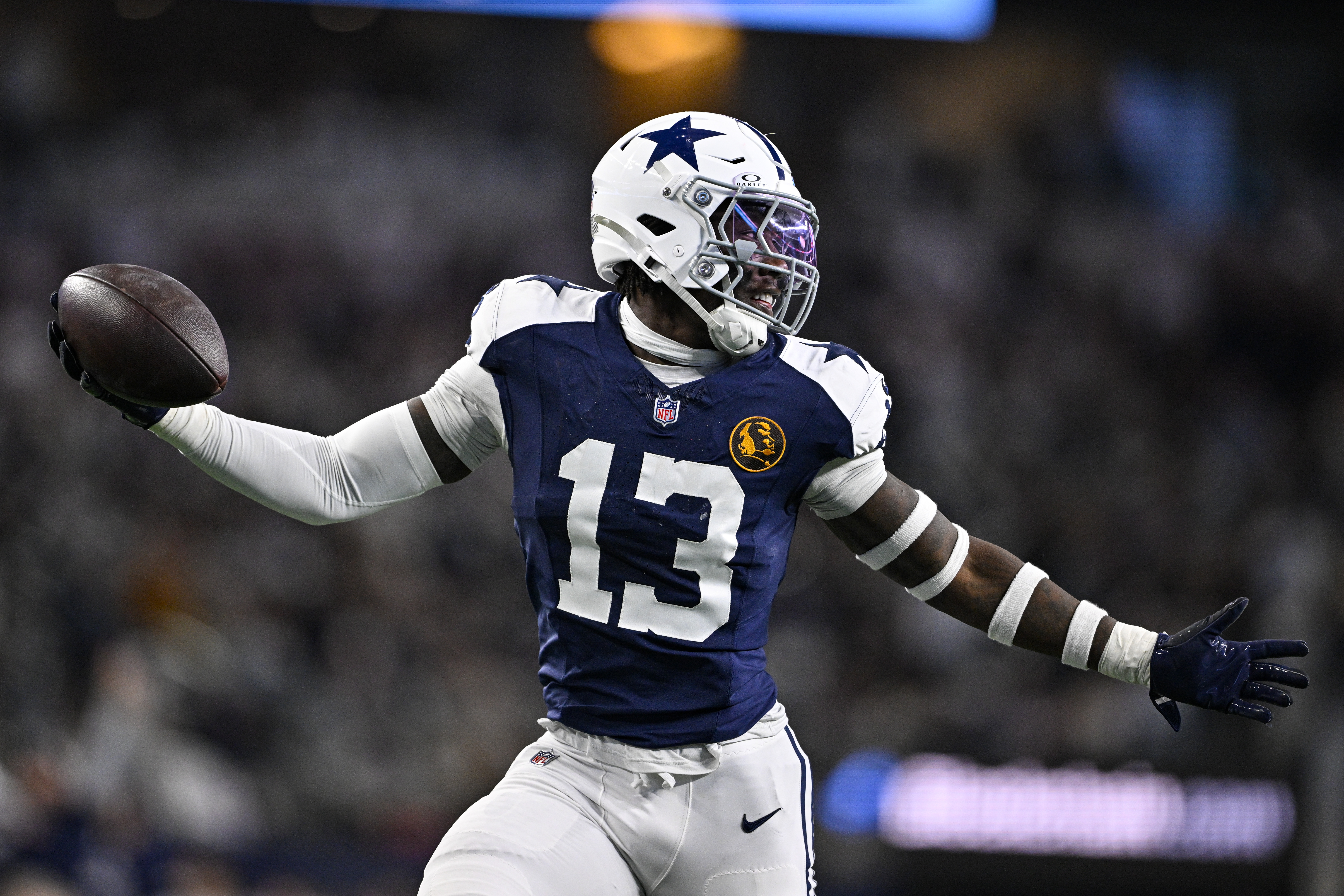 Dallas Cowboys linebacker DeMarvion Overshown (13) celebrates as he runs in for a touchdown on an interception against the New York Giants during the first half of an NFL football game in Arlington, Texas, Thursday, Nov. 28, 2024.