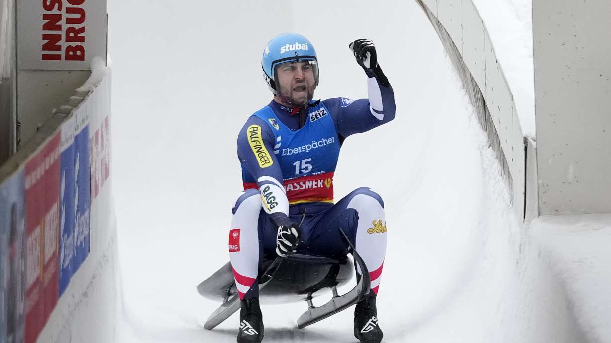 Nico Gleirscher of Austria celebrates winning the men's sprint race at the Luge World Cup in Igls near Innsbruck, Austria, Sunday, Dec. 8, 2024.
