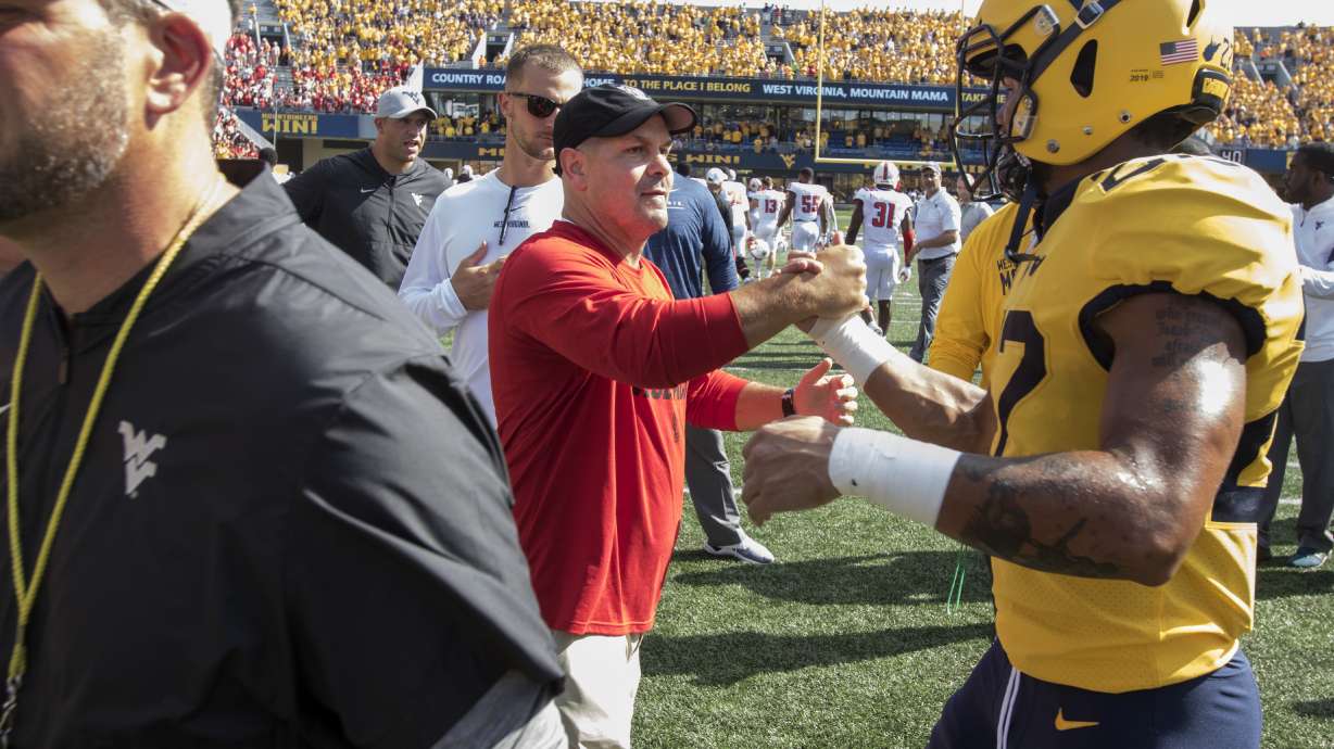 FILE - North Carolina State co-defensive coordinator Tony Gibson shakes hands with West Virginia cornerback Hakeem Bailey (24) at the conclusion of an NCAA college football game, Sept. 14, 2019, in Morgantown, W.Va.