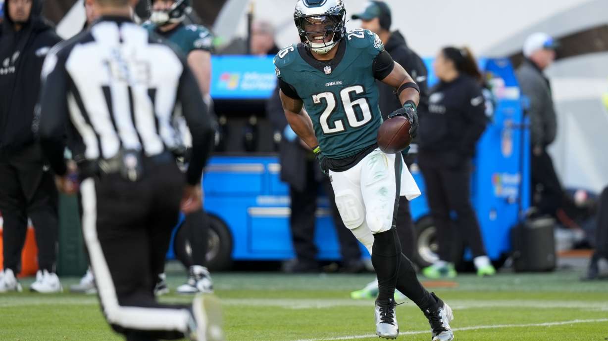 Philadelphia Eagles running back Saquon Barkley reacts after he set the Eagles' season rushing record during the second half of an NFL football game against the Carolina Panthers on Sunday, Dec. 8, 2024, in Philadelphia.