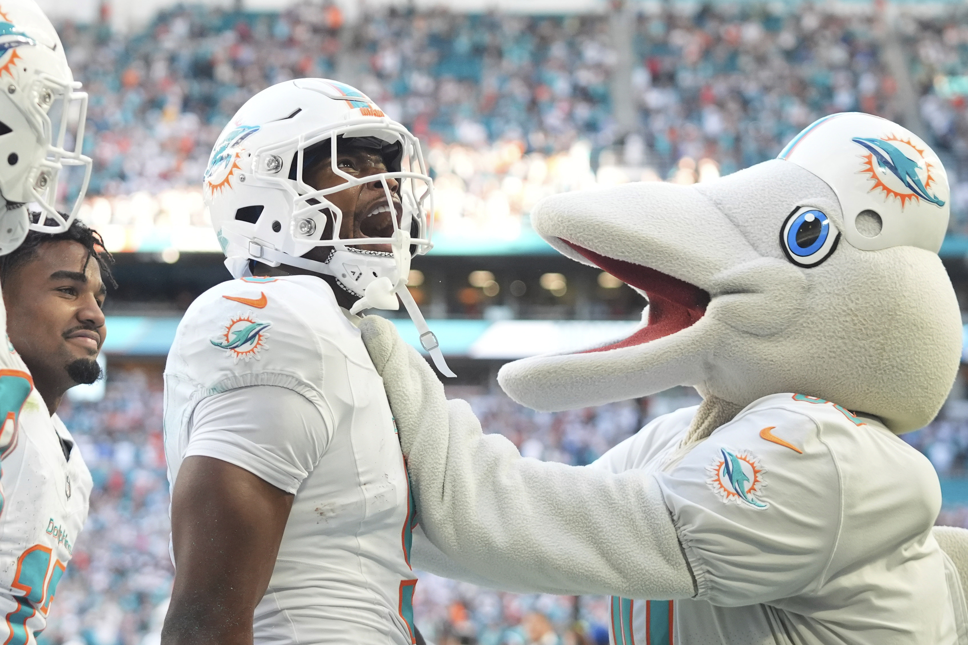 Miami Dolphins tight end Jonnu Smith (9) celebrates a touchdown in overtime during an NFL football game against the New York Jets, Sunday, Dec. 8, 2024, in Miami Gardens, Fla.