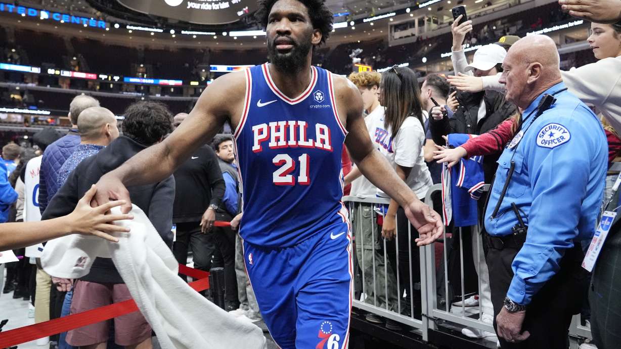 Philadelphia 76ers center Joel Embiid (21) celebrates with fans as he walks off the court after his team defeated the Chicago Bulls in an NBA basketball game in Chicago, Sunday, Dec. 8, 2024.