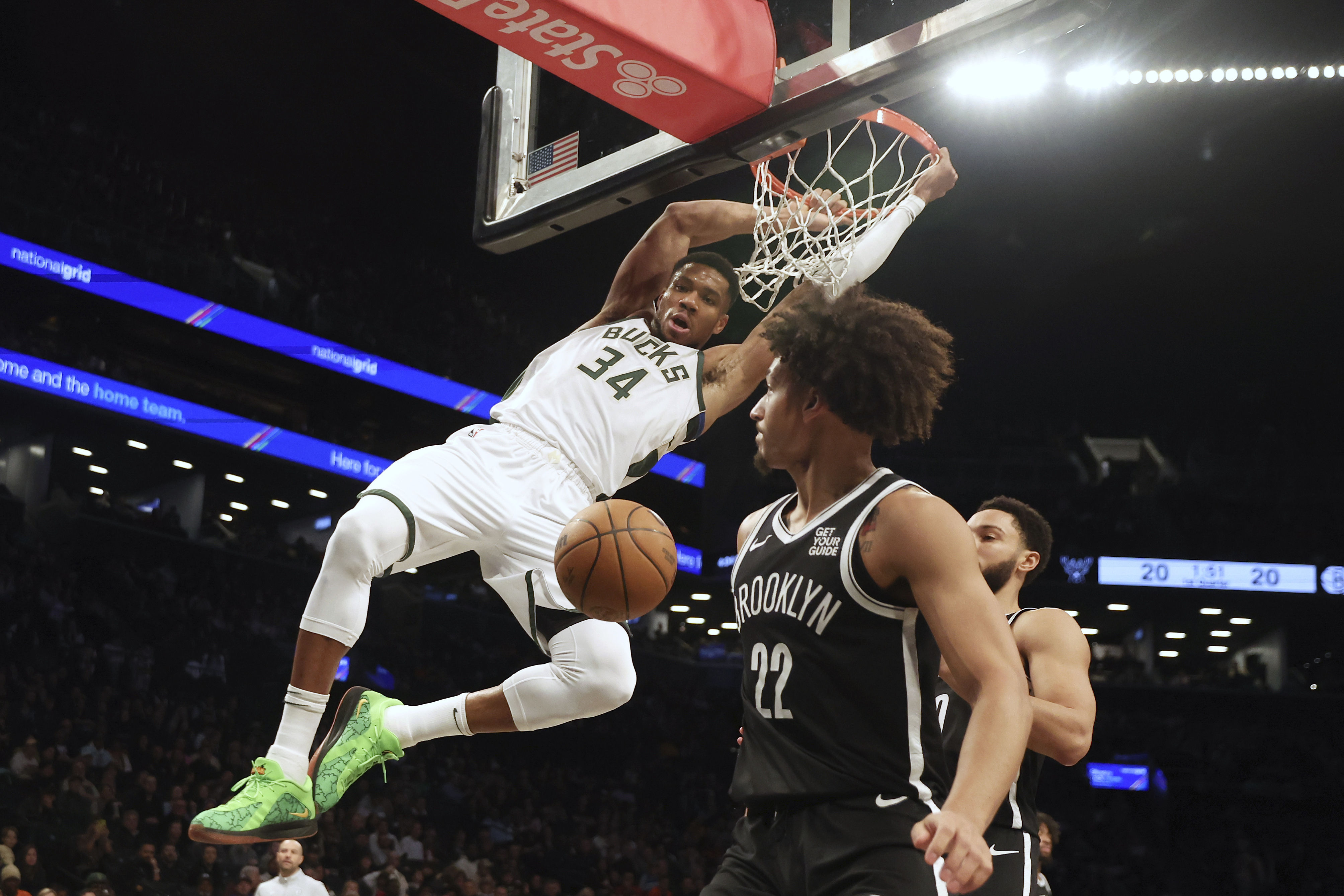 Milwaukee Bucks' Giannis Antetokounmpo dunks the ball past Brooklyn Nets' Jalen Wilson and Ben Simmons during the first half of an NBA basketball game, Sunday, Dec. 8, 2024, in New York.
